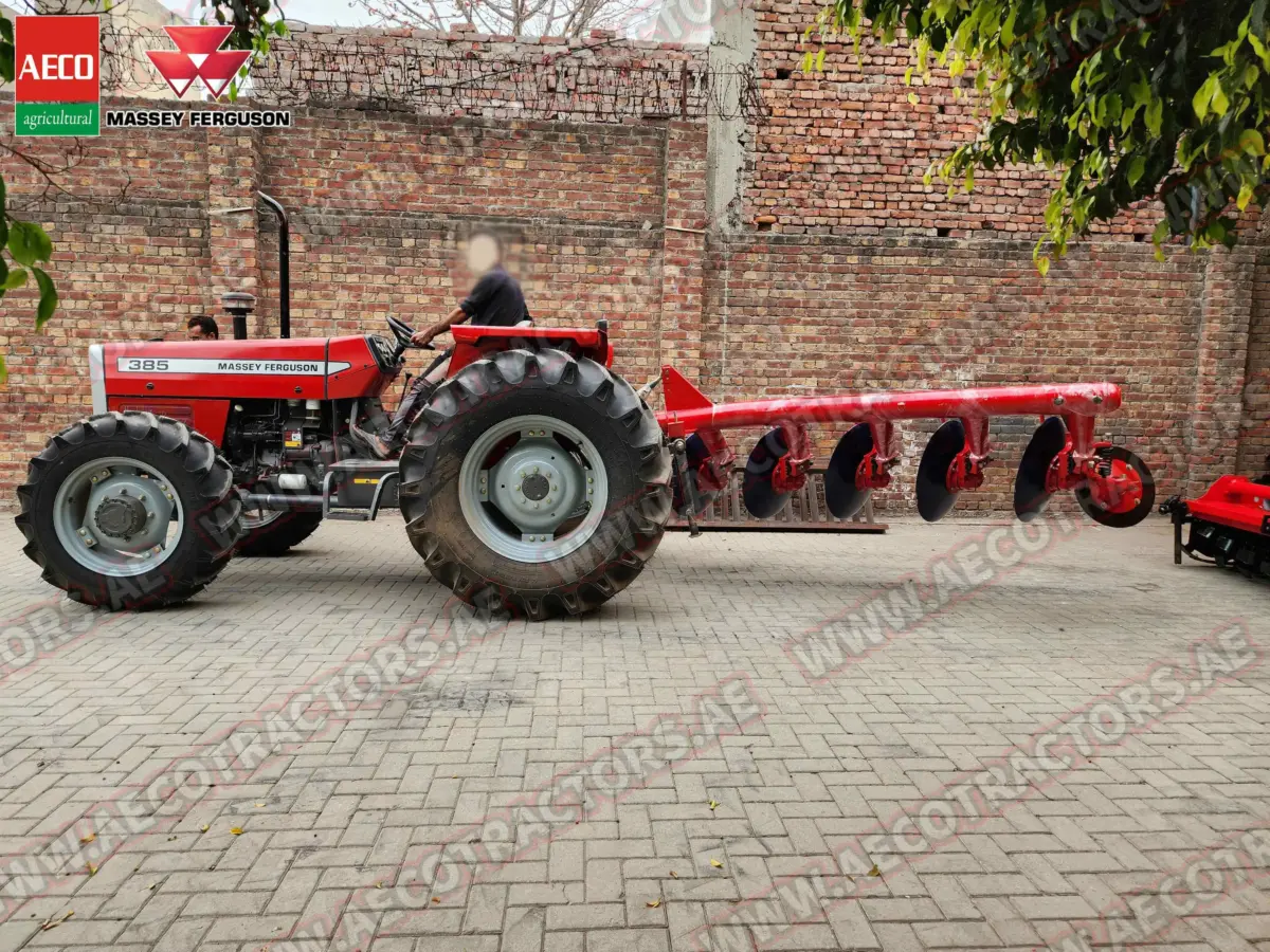 Detailed view of 5 disc plough blades with massey ferguson tractor