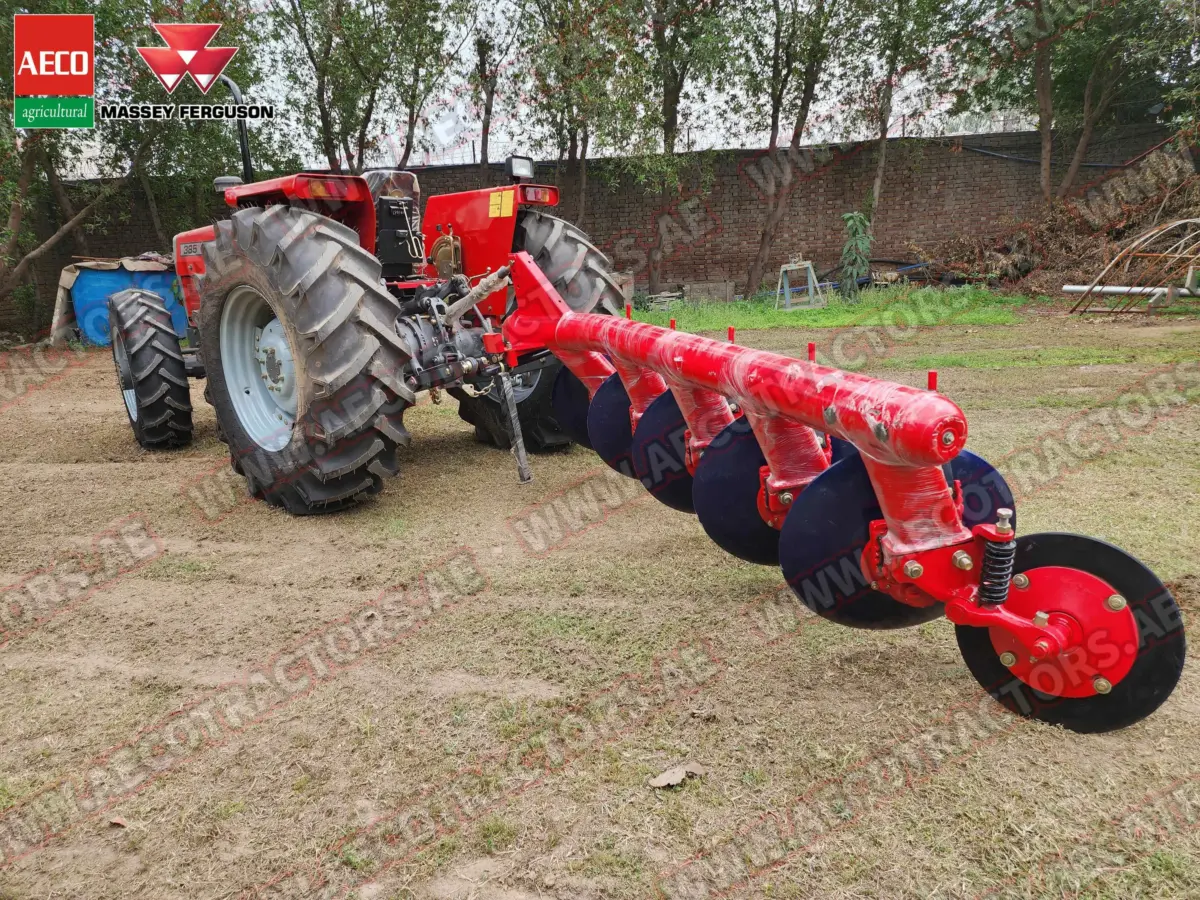 Rear view of tractor with attached 5 disc plough.